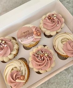 six cupcakes with pink frosting and pearls in a white box on a table