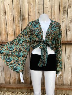 Bohemian Tops With Floral Print And Butterfly Sleeves, Bohemian Floral Print Tops With Butterfly Sleeves, Green V-neck Tops For Festival, Green Butterfly Sleeve Tops For Spring, Green V-neck Hippie Top, Flowy Bell Sleeve Tops For Festival, Green Boho Print Long Sleeve Top, Green Floral Print Crop Top, Green Long Sleeve Top With Boho Print