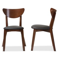 two wooden chairs side by side with black leather seats on the back and one has a dark colored seat