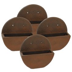 three round iron pots sitting on top of each other with holes in the middle and bottom