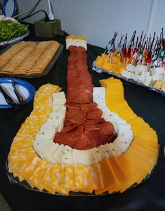 a table topped with plates and trays filled with different types of food on top of it