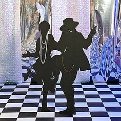 the silhouettes of two people are standing on a checkered floor in front of mirrors