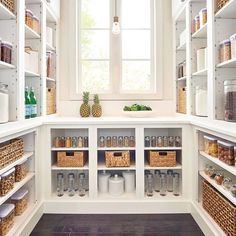 an organized pantry with lots of food in the cupboards and baskets on the shelves