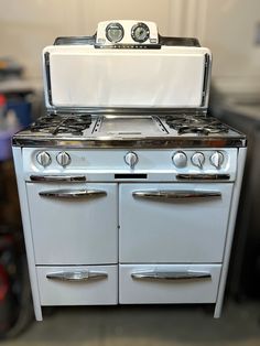 an old fashioned stove with two ovens on top