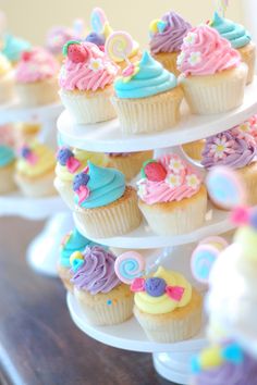 cupcakes with colorful frosting and decorations on a cake stand