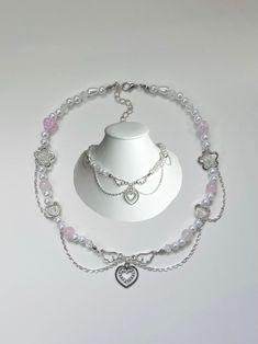 An Angel inspired beaded necklace which incorporates silver chains to excentuate its soft pink feminine design. This necklace was designed and hand crafted by myself with care and very close attention to detail to give off a delicate princess aesthetic. Each one of the beads and charms where carefully placed by me to enhance its coquette touch.  Perfect as a gift to your friend or sister for their birthday (or any occaistion!). Also perfect as a gift for yourself! Your order wil include a clear ziplock storage bag for your necklace and instructions on how to care for your new jewellery.  The default length of this necklace measures to 15' inches with a 2.5' inch extension chain.  If you wish to customize it to your desired length, feel free to add your request in the personalisation tool b Beaded Heart Necklace, Pink Feminine, Beaded Heart, Heart Charm Necklace, Silver Chains, Princess Aesthetic, Feminine Design, Pink Gifts, An Angel