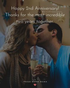 a man and woman kissing while holding champagne glasses in front of them with the words happy 2nd anniversary thanks for the most incredible two years together