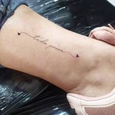 a woman's foot with a tattoo that says, love is in the air