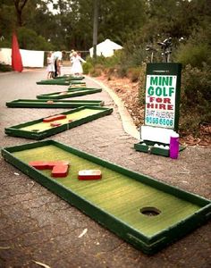 several mini golf courses lined up on the sidewalk