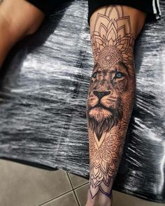 a man with a lion tattoo on his leg