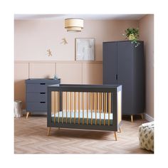 a baby's room with a crib and dresser