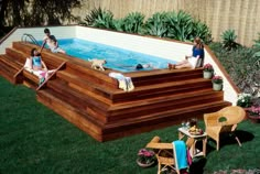 an above ground swimming pool with people sitting in it and two dogs on the deck