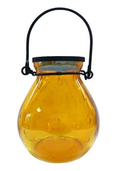 a yellow glass vase with a black handle