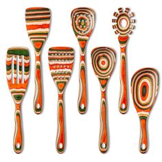 five wooden utensils are lined up on a white background, each with different designs