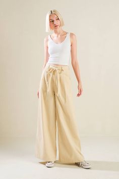 A solid woven pant featuring front closure, self sash tie, front pleat and wide leg The Fame, Flying Tomato, Skirt Jumpsuit, Sweatshirt Dress, Baby Month By Month, Wide Leg, Women Jeans, Pants