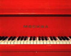 a red piano with the word mockba written on it's front side