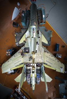 a fighter jet sitting on top of an airport tarmac