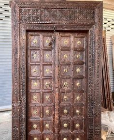 an old wooden door with many knobs on it's front and side doors