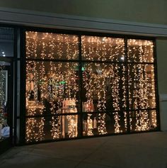 the window is decorated with lights and bottles