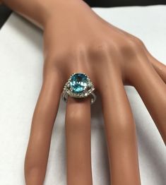 7.80 Carats Natural Very Nice Looking Blue Zircon and Diamond 14K Solid White Gold Ring Suggested Replacement Value: $6,500.00 Total Natural Oval Cut Blue Zircon Weight is: 7.00 Carats Natural Round Diamonds Weight: .80 Carats (color G-H / Clarity SI1-SI2) Ring total weight: 6.1 grams Disclaimer: all weights, measurements and colors are approximate and may vary slightly from the listed dimensions or as seen in the image. All pictures are magnified to show the smallest of details. Please, refer t Formal Aquamarine Diamond Ring With Brilliant Cut, Aquamarine Brilliant Cut Diamond Ring For Formal Occasions, Exquisite Diamond Topaz Ring For Formal Occasions, Blue Topaz Ring In 14k White Gold, Formal Aquamarine Ring With Diamond Accents, Formal Blue Brilliant Cut Gemstones, Blue Brilliant Cut Gemstones For Formal Occasions, Formal Aquamarine Diamond Ring With Prong Setting, Luxury 14k White Gold Topaz Ring With Center Stone