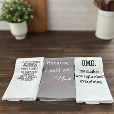 three napkins with words on them sitting on a table