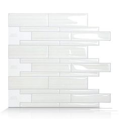 a white glass tile wall that has been designed to look like it is floating in the air