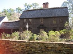 an old house with stone walls in front of it