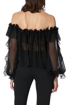 Captivate in this sheer silk-chiffon blouse detailed with ruffles down the sleeves and around the off-the-shoulder neckline punctuated by a glorious rosette. 23" center front length (size 16) Off-the-shoulder halter neck Long sleeves Sheer 100% silk Dry clean Made in the USA of imported fabric Women's Designer Clothing Latinx Owned/Founded Off-shoulder Chiffon Blouse, Sheer Silk Chiffon Top For Evening, Chic Chiffon Tops With Sheer Sleeves, Evening Ruffled Organza Top, Evening Organza Top With Ruffles, Off-shoulder Chiffon Party Tops, Elegant Ruffle Sleeve Evening Blouse, Off-shoulder Chiffon Blouse For Party, Elegant Chiffon Top For Night Out