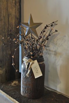 a mason jar with branches and berries in it on a shelf next to a door