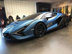 a blue sports car parked in a showroom