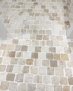 a white toilet sitting on top of a tiled floor