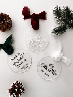 three personalized christmas ornaments with pine cones