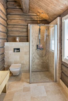 a bathroom with a walk in shower next to a toilet