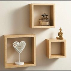 three square wooden shelves with decorative items on them