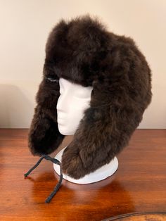 Experience ultimate luxury with our handmade Baby Alpaca Fur Trapper Hat. Crafted in the Andes region of Peru, this hat feels like a cozy cloud hugging your head. Perfect for outdoor activities like hiking, hunting, or living off-grid, it’s loved by hunters for its exceptional warmth—warmer than polar bear fur—while also regulating heat. Stay comfortable without overheating, as it adjusts to keep you warm when needed and cool when it’s not. The hypoallergenic baby alpaca fur on this Alpaca Fur T Warm Brown Hat For Outdoor Activities, Warm Brown Hats For Outdoor Activities, Brown Hats With Ear Flaps For Outdoor Activities, Brown Hats With Ear Flaps For Outdoors, Adjustable Alpaca Hat For Outdoor, Sheepskin Hats With Ear Flaps For Outdoor, Adjustable Alpaca Hat With Ear Flaps, Warm Faux Fur Hats With Ear Flaps, Trapper Hat Men