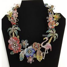 (`'.(`'.(`'. Christian Sirianos .').').') Beautiful Floral Flamingo Rhinestone Necklace By Christian Sirianos This Colorful, Vibrant Necklace Is A Show Stopper!!! Stunning, "Tropical Garden/Hawaiian" Necklace. It Is A Large Piece And Makes Quite A Statement With Colorful Tropical Flowers, Palm Trees And A Pink Flamingo! It Is Done With Hundreds Of Tiny Multicolored Stones And Teardrop Broilettes. It Is A Truly A Work Of Art! It Is Adjustable From 18 To 20". Material Of Necklace : Zinc Alloy From Christian Siriano Jewelry, Silver Feather Necklace, Vintage Chain Necklace, Hawaiian Necklace, Infinity Necklace Silver, Rose Choker, Smoky Quartz Pendant, Crystal Heart Necklace, Square Necklace