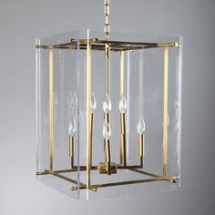 a clear and gold chandelier hanging from a ceiling fixture with three lights on each side