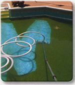 an image of a pool being cleaned with blue towels and water hoses on the ground