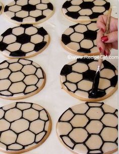 the cookies are decorated with black and white soccer balls