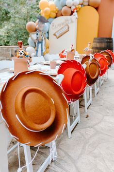 there are many hats on the tables at this birthday party that is ready to be eaten