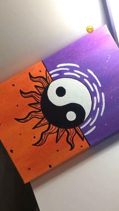 an orange and purple painting with a black yin sign on it