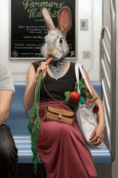 a woman sitting on a subway car with a bunny mask and carrot in her mouth