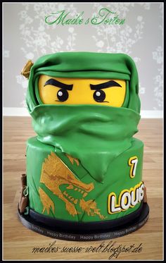 a cake made to look like a lego ninja's head with the words i love you written on it