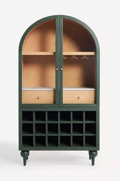 a green cabinet with shelves and drawers