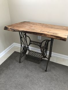 an old sewing machine sits on top of a table in the corner of a room