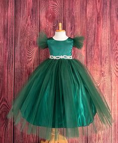 This beautiful elegant dress is one of my favorite! So modern and classy for any special occasion. Bodice is made of Hunter Green satin followed by fluffy Hunter Green tulle sleeves, waistline consists of a rhinestone band (not removable) a hidden zipper can be found in the back of the dress. The skirt consist of 2 Hunter Green Tulle layers, a layer of Hunter Green satin followed by lining with crinoline for fullness. Dress is pictured with Petticoat to show full detail. NOT INCLUDED https://www.etsy.com/listing/1305138635/white-petticoat-wedding-bridesmaids?click_key=c98dd4420cf3925879eead78fd2d73c6223871f5%3A1305138635&click_sum=37390cf8&ref=shop_home_active_3&crt=1 Visit our store, more items to come!  https://www.etsy.com/shop/LittledarlnBoutique?ref=profile_header CUSTOM MEASUREMENTS Holiday Princess Dress Ball Gown For Dress-up, Princess Style Green Ball Gown For Pageant, Holiday Princess Ball Gown For Fancy Dress, Princess Ball Gown For Holiday Fancy Dress, Fitted Tulle Holiday Dress For Fancy Occasions, Elegant Christmas Princess Dress In Tulle, Elegant Tulle Ball Gown For Christmas, Fitted Tulle Dress For Fancy Dress Holiday, Elegant Christmas Tulle Princess Dress