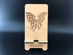 a wooden business card holder with an american flag eagle on it's front and back