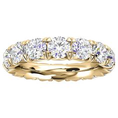 a yellow gold wedding band with five round cut diamonds on the top and bottom side