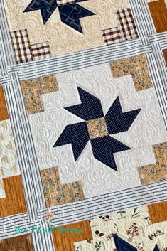 a quilted table topper with blue stars on it