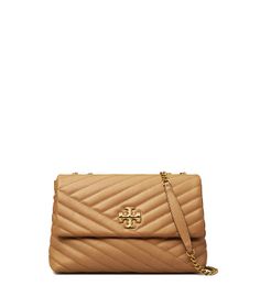 Directly from Tory Burch - The Kira Convertible Shoulder Bag is made of soft chevron-quilted leather with beveled Double T hardware. An adjustable chain strap adapts in the moment - doubled over the shoulder, or long and crossbody. Tory Burch Official Site. Kira Chevron Convertible Shoulder Bag, Tory Burch Kira Chevron, Kira Chevron, Tory Burch Kira, Womens Designer Handbags, Leather Roll, Designer Shoulder Bags, Quilted Leather, Chain Strap